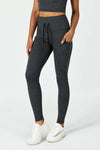 CloudFleece™ High-Waist Drawstring Legging in Dark Heather Grey with side pockets, shown on a model against a white background