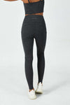 Woman wearing CloudFleece™ High-Waist Drawstring Legging in Dark Heather Grey showing back view with U-shaped back seam and side pockets.